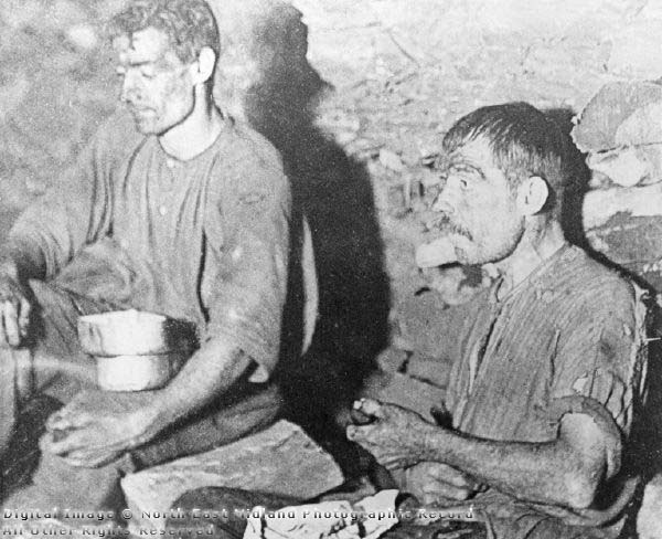 Two miners eating their snacks during a break