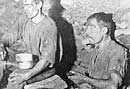 Two miners eating snacks in the mine